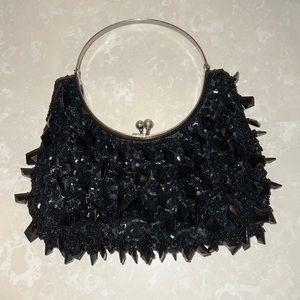 Small beaded purse with metal handle. New. Never used.